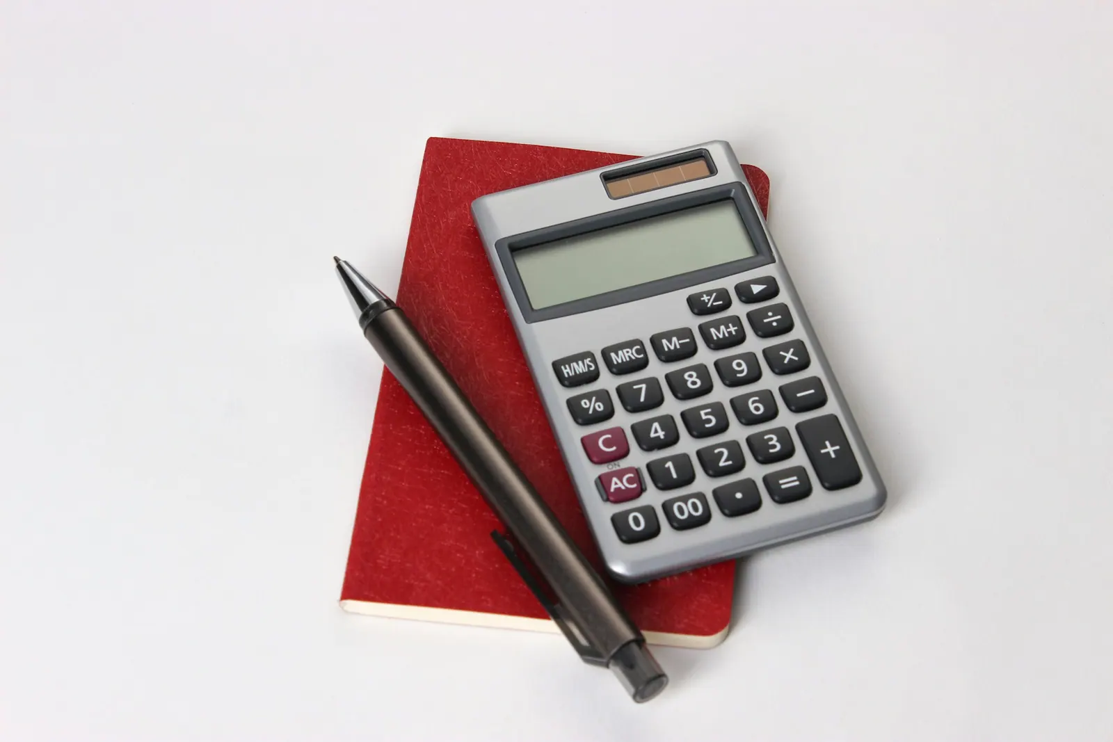 Calculator and notebook on a desk