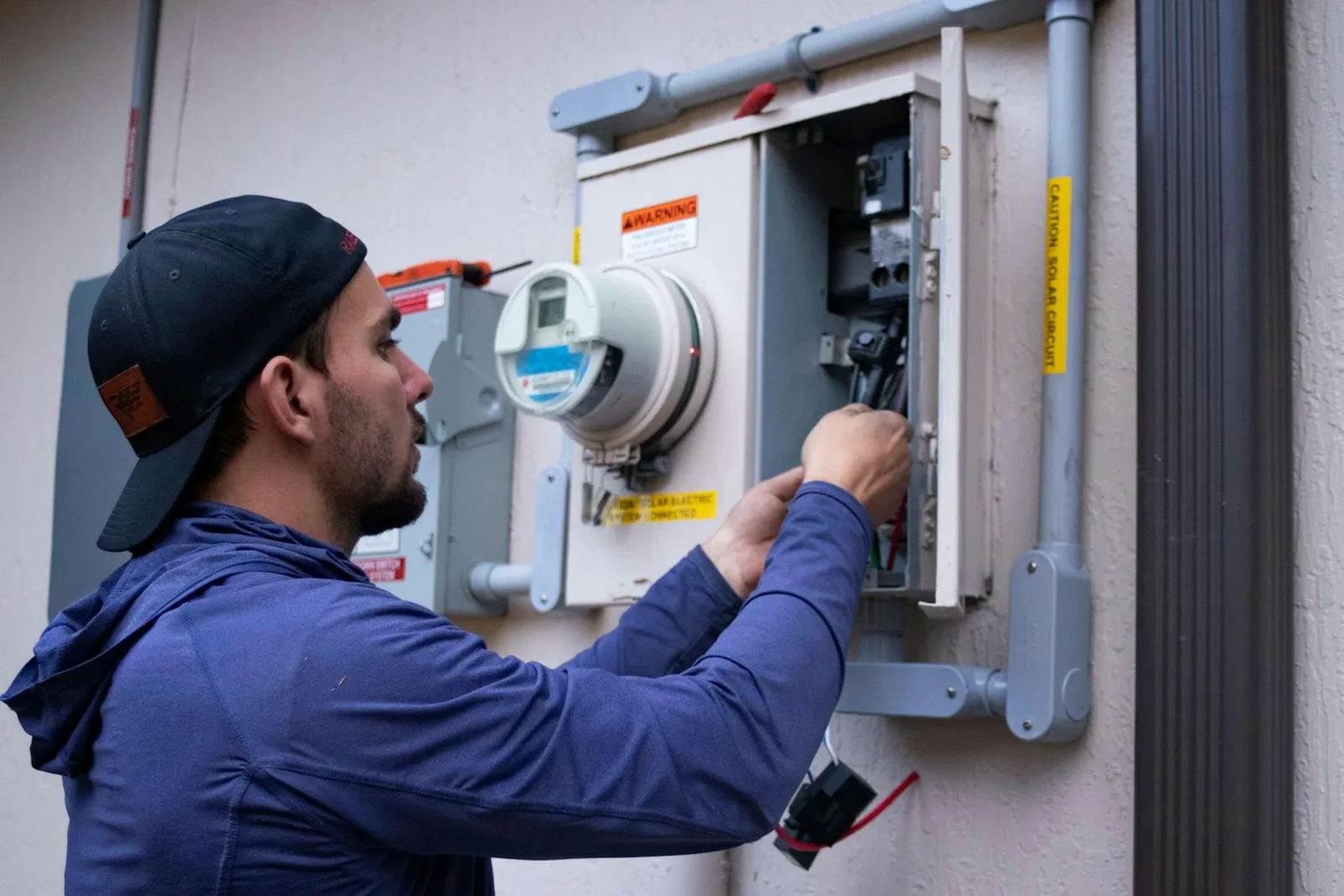 Electrician working on a home meter box