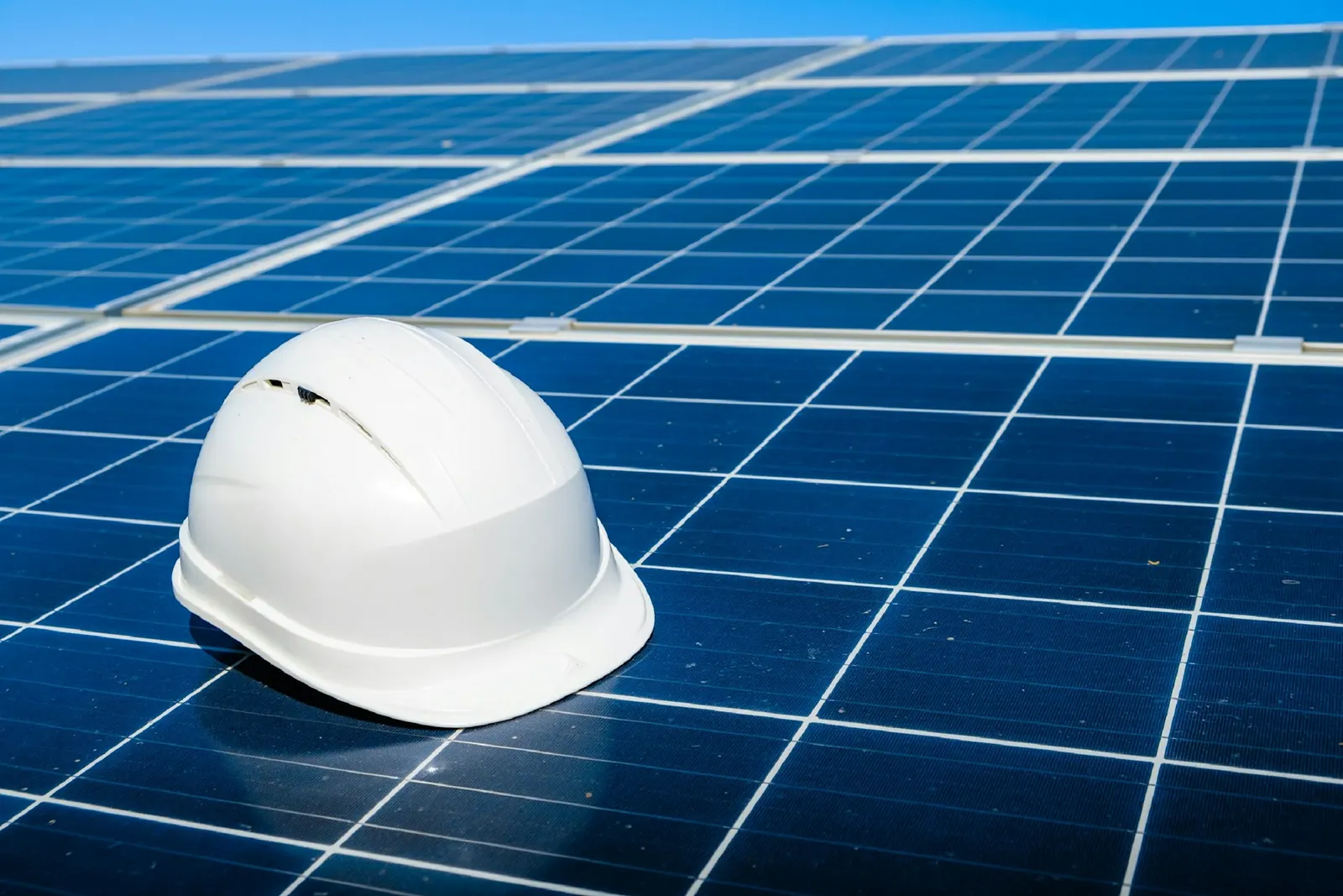 Hard hat resting on a solar panel