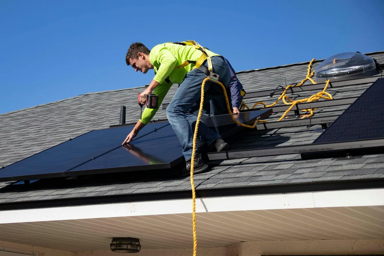 Installer fitting solar panels on a tiled roof