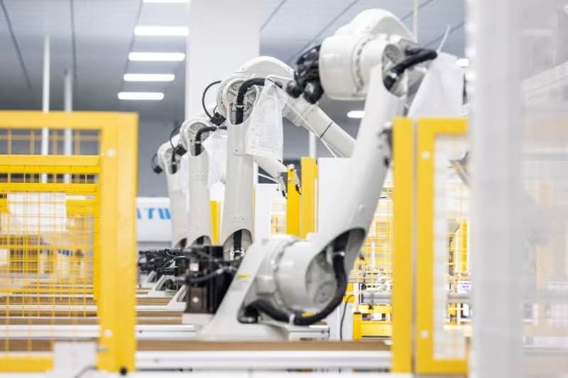 Robotic quality control stations inspecting solar panels on the factory assembly line